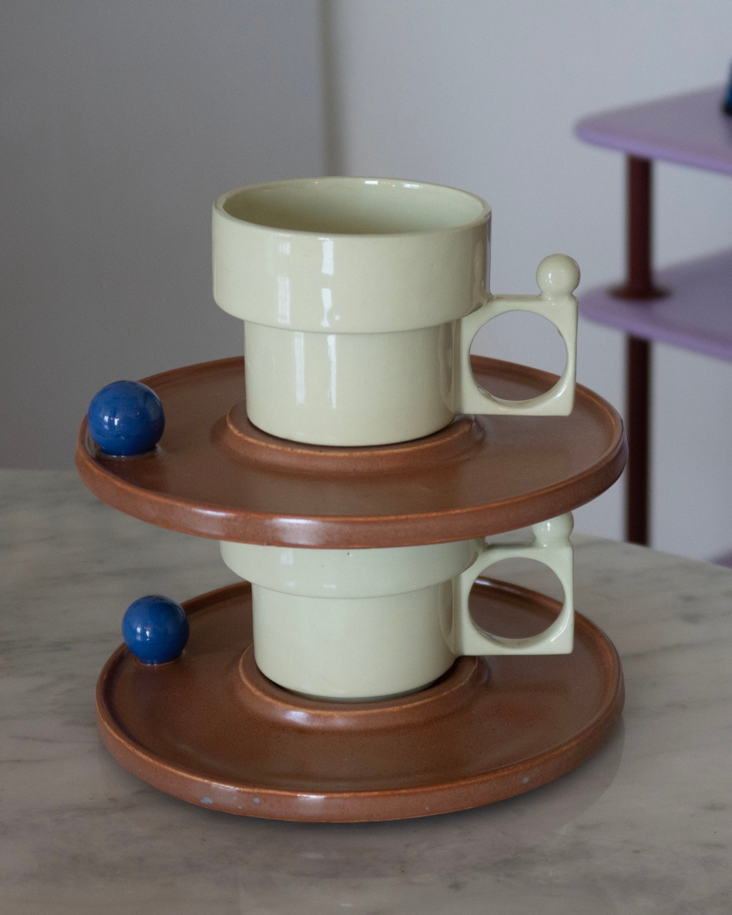 Ceramic mug with a wooden base on a marble surface