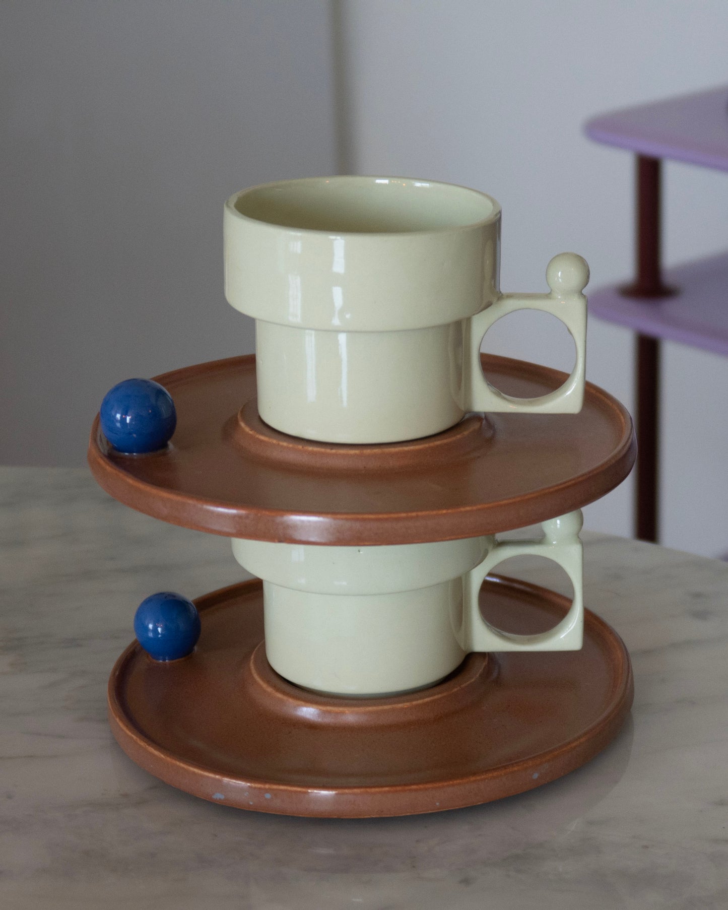 Ceramic mug with wooden base on a marble surface