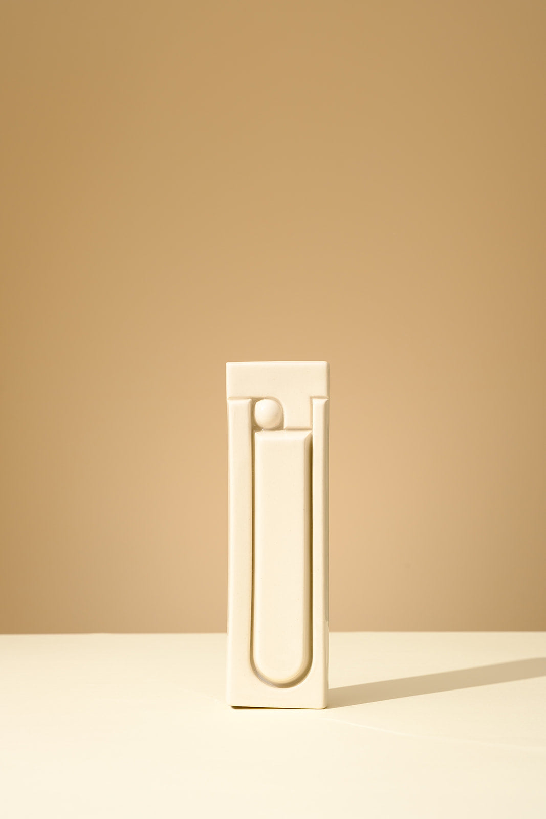 Handmade ceramic mezuzah in glossy olive green glaze, featuring a minimalist geometric relief design, crafted in Israel