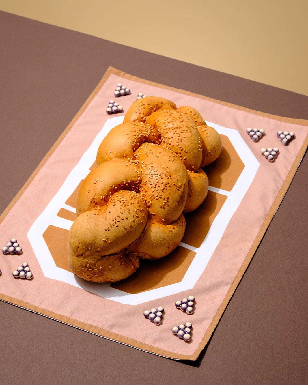 Designer challah cover handmade in Tel Aviv, combining modernist Hebrew typography, textile design, and ceramic beadwork.