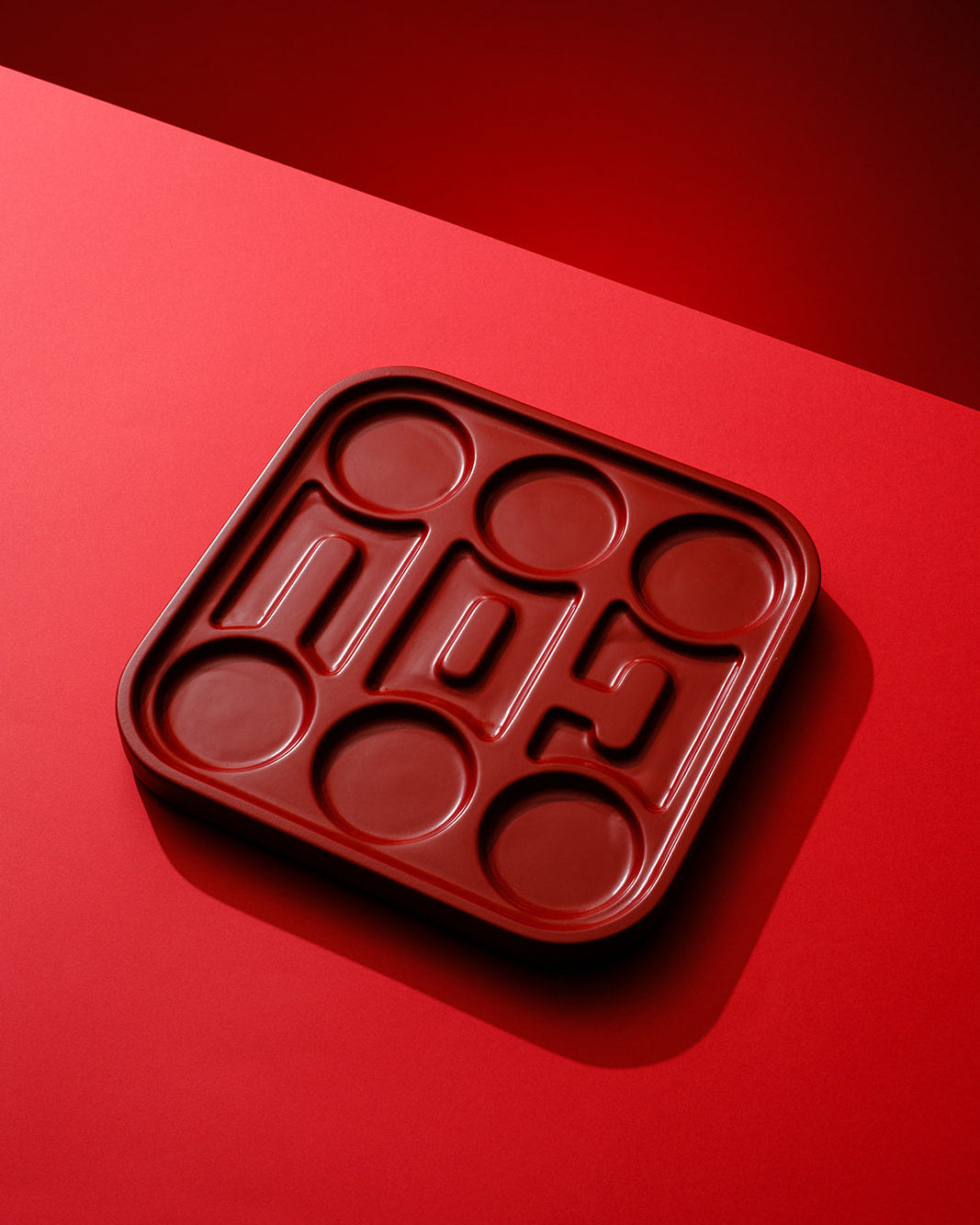 Handmade red wooden Passover Seder plate with built-in ceramic bowls, designed in a modern geometric form