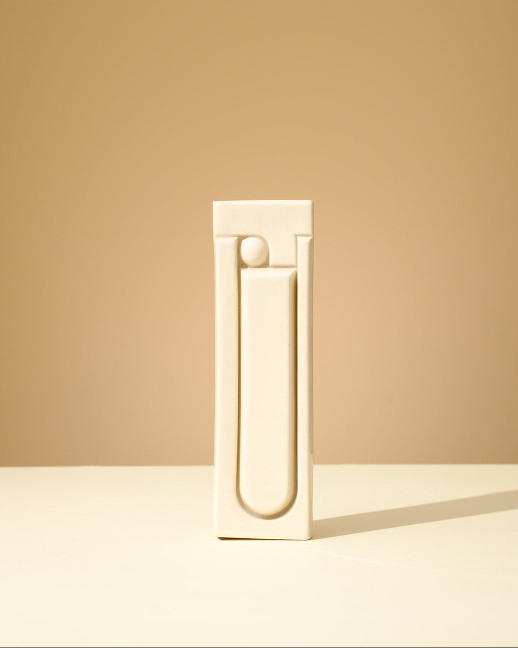 Handmade ceramic mezuzah in glossy olive green glaze, featuring a minimalist geometric relief design, crafted in Israel