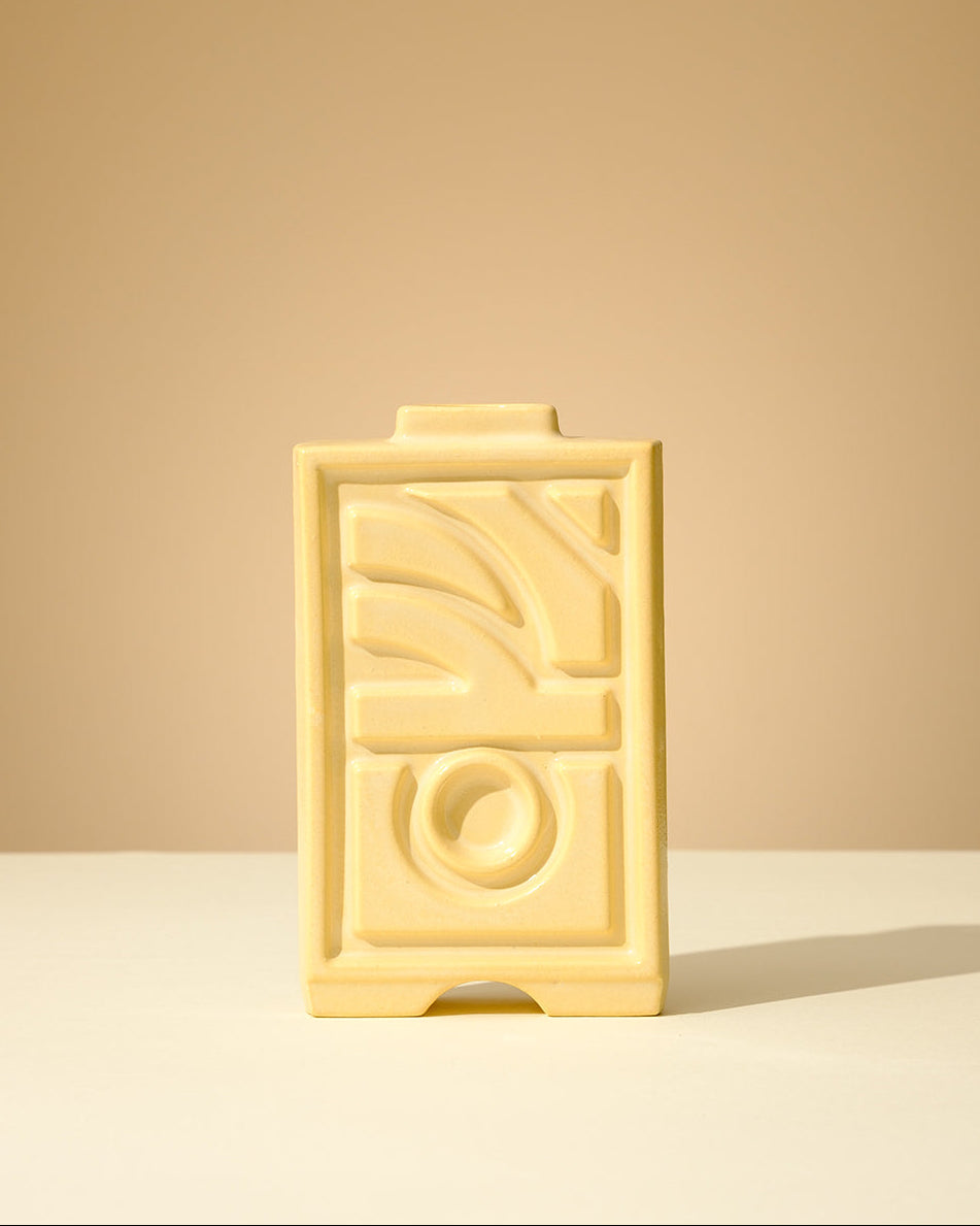 Handmade ceramic Judaica piece with a soft celadon glaze, featuring geometric relief patterns, crafted in Tel Aviv