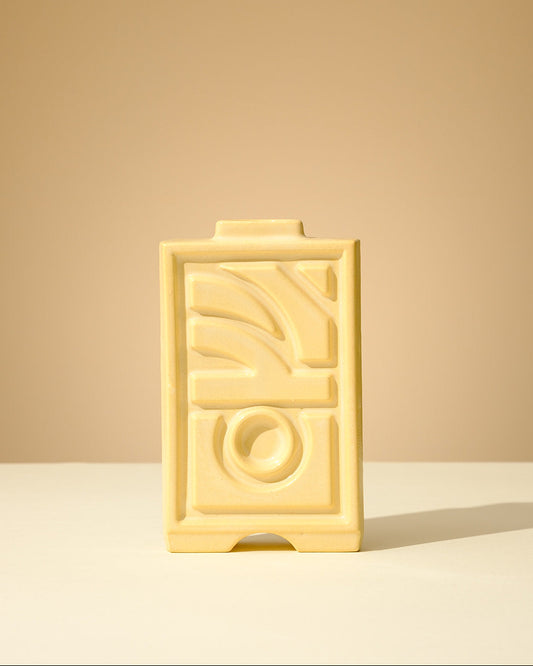 Handmade ceramic Judaica piece with a soft celadon glaze, featuring geometric relief patterns, crafted in Tel Aviv