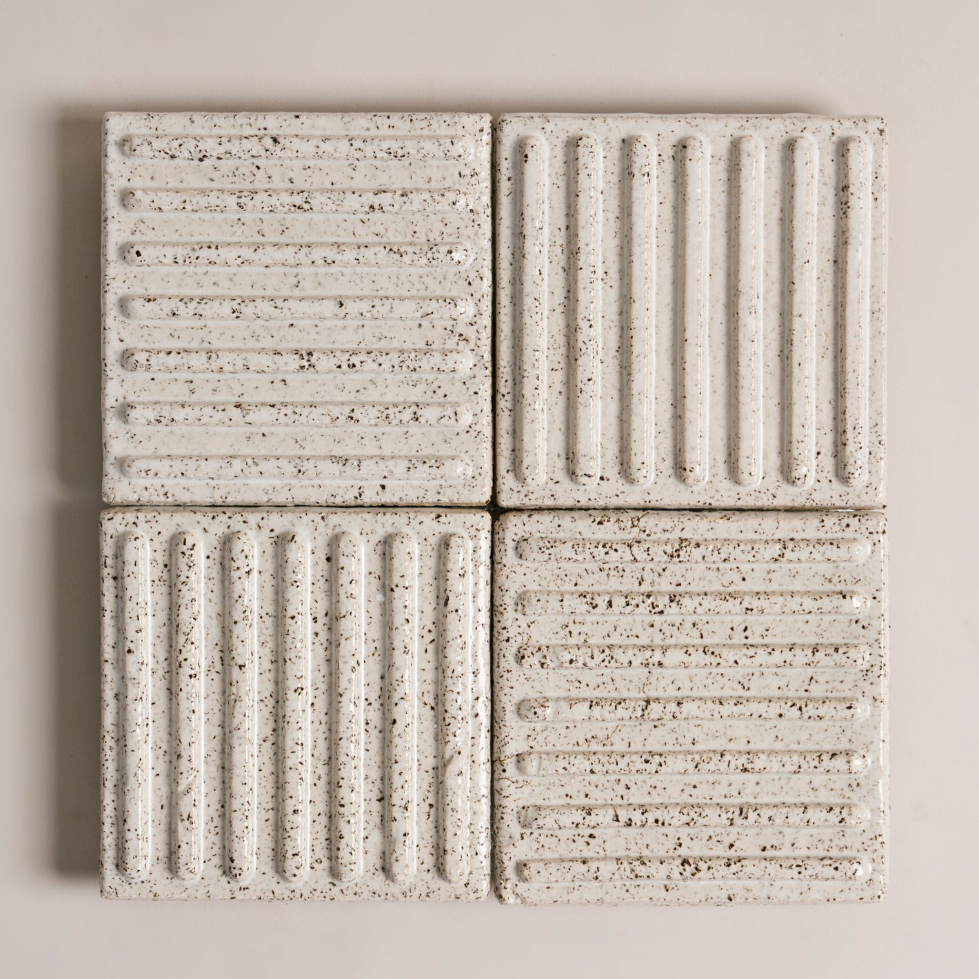 Minimal and refined interior design with custom sculptural wall work, ceramic art installation integrated into modern architecture